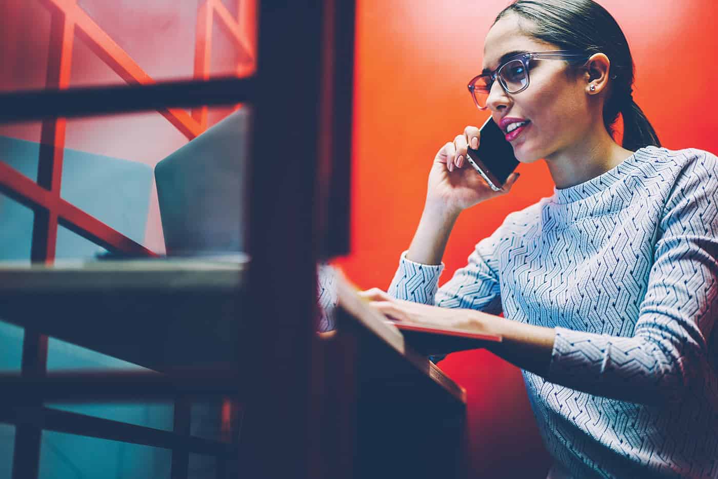 Woman working in an office phone booth