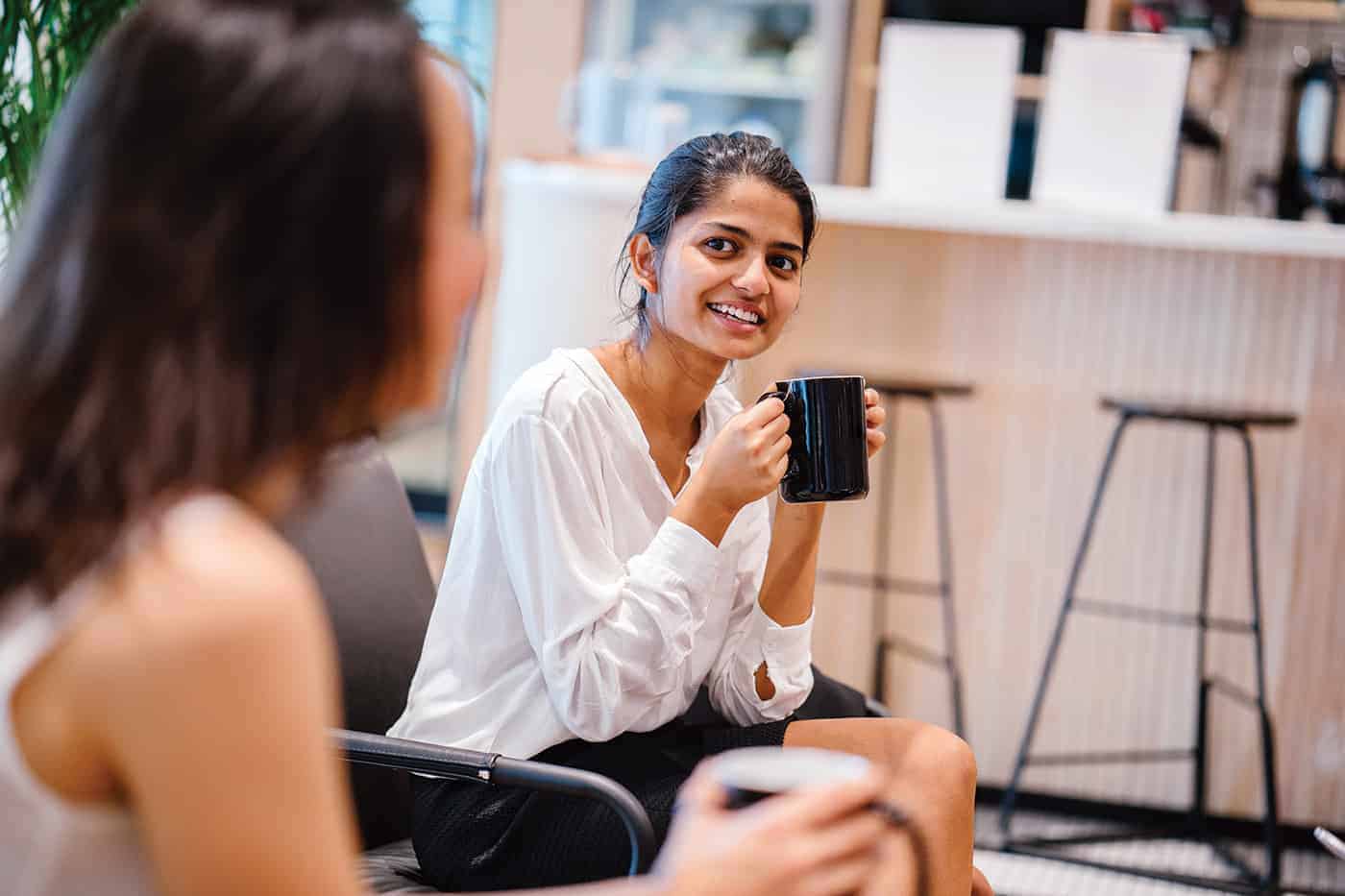 Women meeting in an open office environment