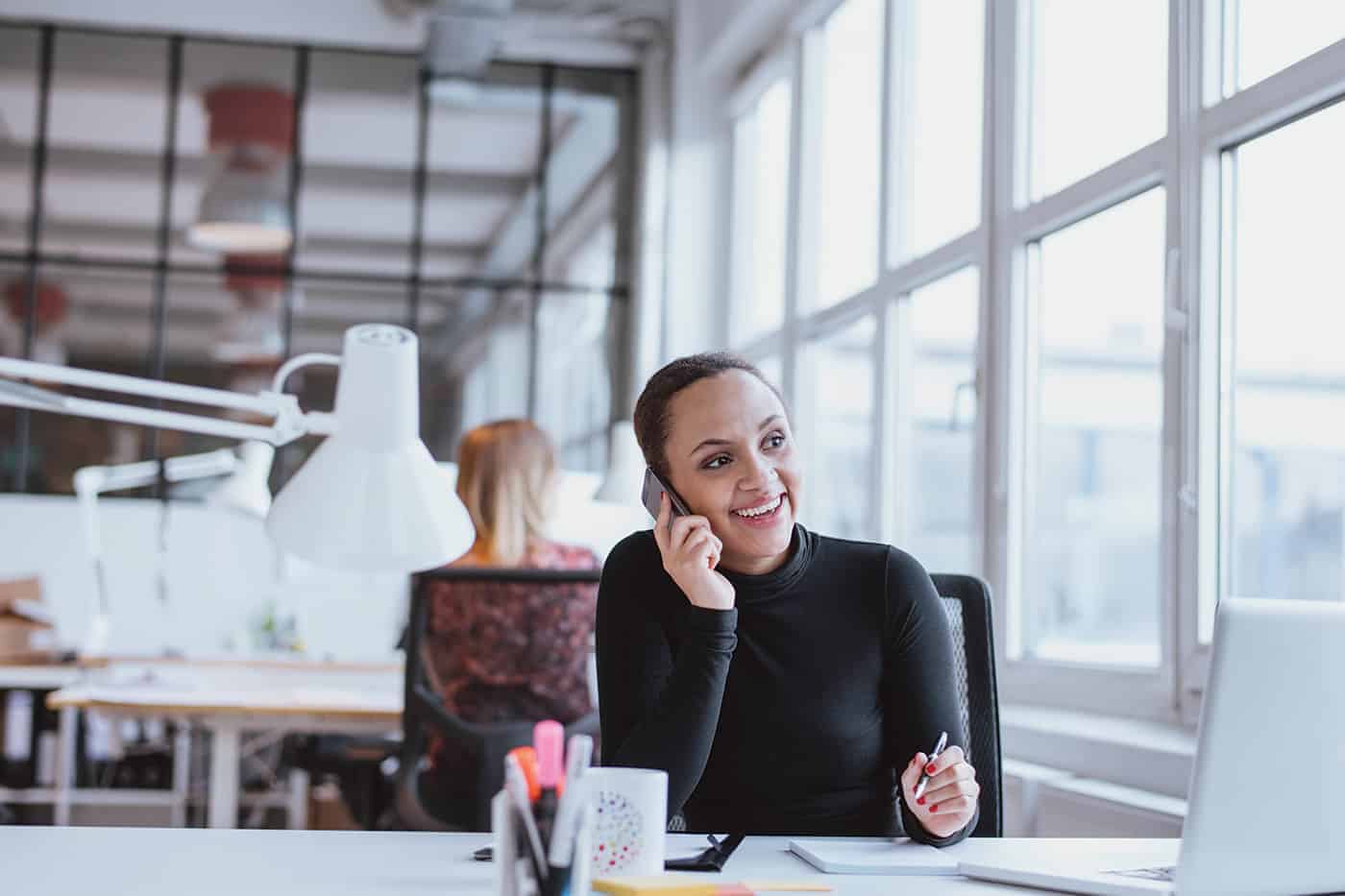 Woman on the phone at office desk