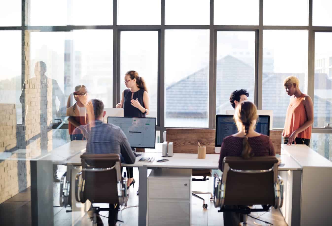 Workers collaborating at open office benching