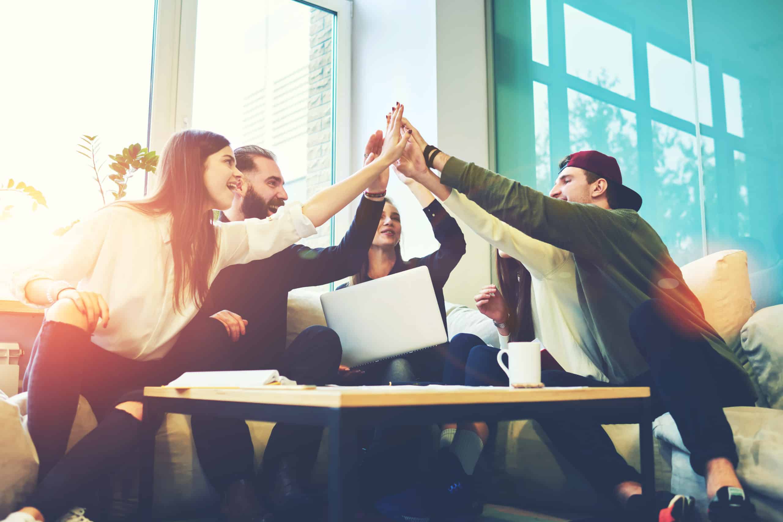 colleagues sitting around table in resimercial office