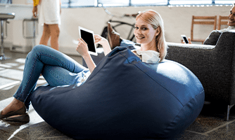 Woman sitting on bean bag with tablet